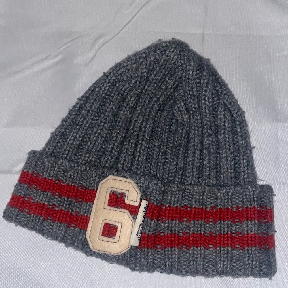 Gray Knit Beanie with Red Stripes and Number 6 Patch
